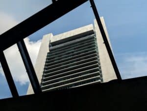 The Federal Reserve Bank of Boston's downtown Boston office tower seen framed in the canopy of a South Station subway headhouse.